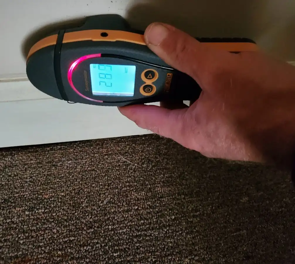 Moisture detection at baseboard during Storm Damage Restoration in Lone Grove